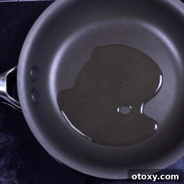 Healthy Zucchini Fritters: Gluten-Free, Paleo and Whole30 8 Olive oil heating in a black skillet pan on the stove