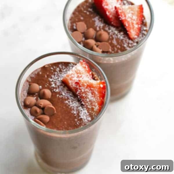 Rich Chocolate Chia Pudding in a jar topped with fruit and chocolate shavings