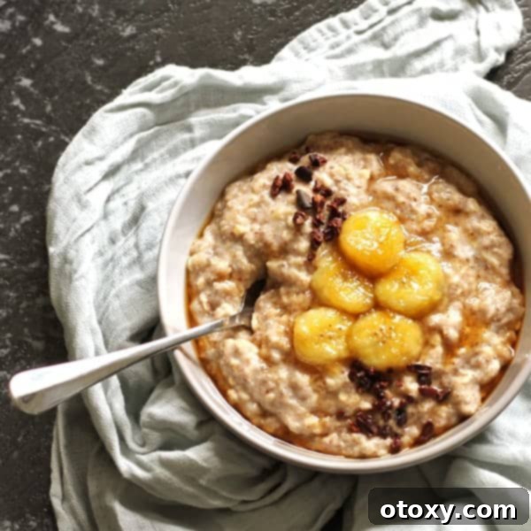 Bowl of Easy Stovetop Banana Oatmeal topped with banana slices and cinnamon