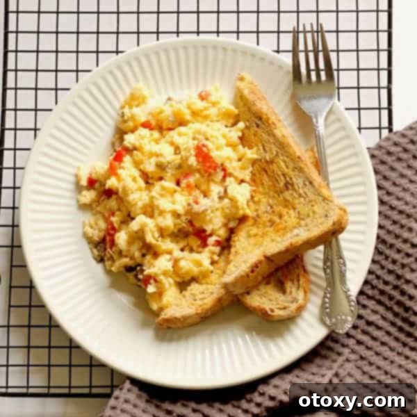 Fluffy Scrambled Eggs with colorful vegetables and a sprinkle of cheese