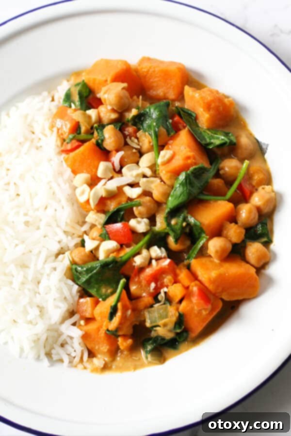 Wholesome Sweet Potato, Chickpea, and Spinach Curry 4 close up of sweet potato, chickpea and spinach curry in a bowl with rice