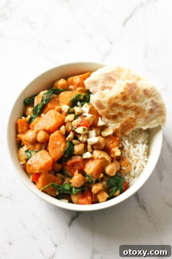 Wholesome Sweet Potato, Chickpea, and Spinach Curry 5 sweet potato, chickpea and spinach curry in a bowl with rice surrounded by vegetables