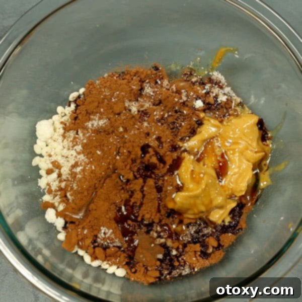 healthy chocolate crackles ingredients in a glass mixing bowl 