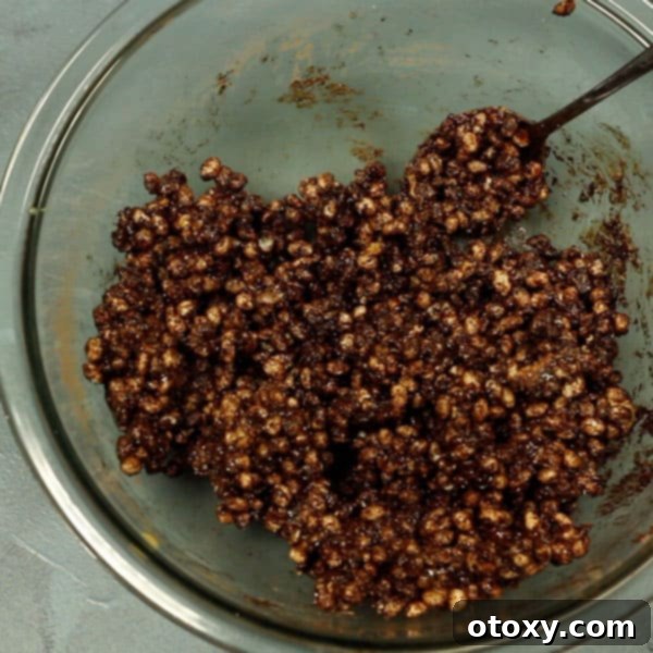 healthy chocolate crackles ingredients mixed together in a glass bowl 