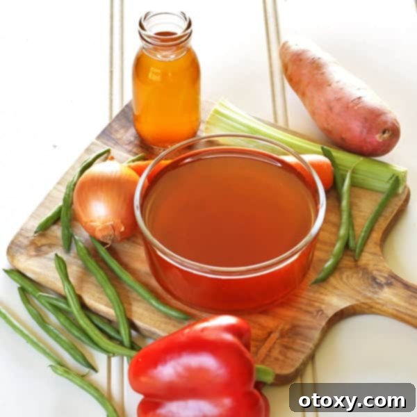 A slow cooker filled with vegetable scraps and water, ready to be cooked into homemade vegetable stock.
