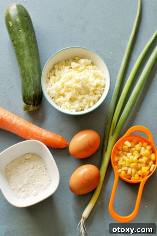zucchini haloumi fritters ingredients laid on top of a blue background