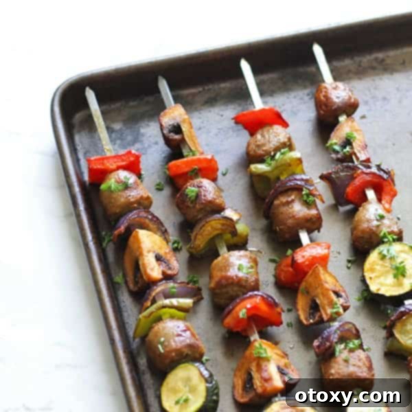 Four perfectly grilled sausage and veggie skewers artfully arranged on a sleek baking tray, showcasing a delicious, healthy, and easy dinner option.