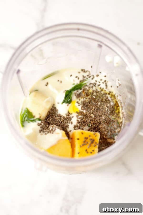 spinach mango smoothie ingredients in a blender cup