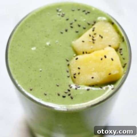 Tropical Kale Power Smoothie 5 kale pineapple smoothie in a short glass topped with pineapple pieces and chia seeds