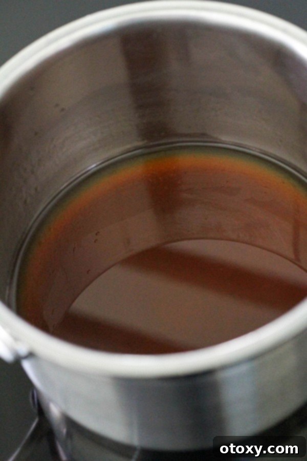 Salad dressing being gently heated in a small saucepan.