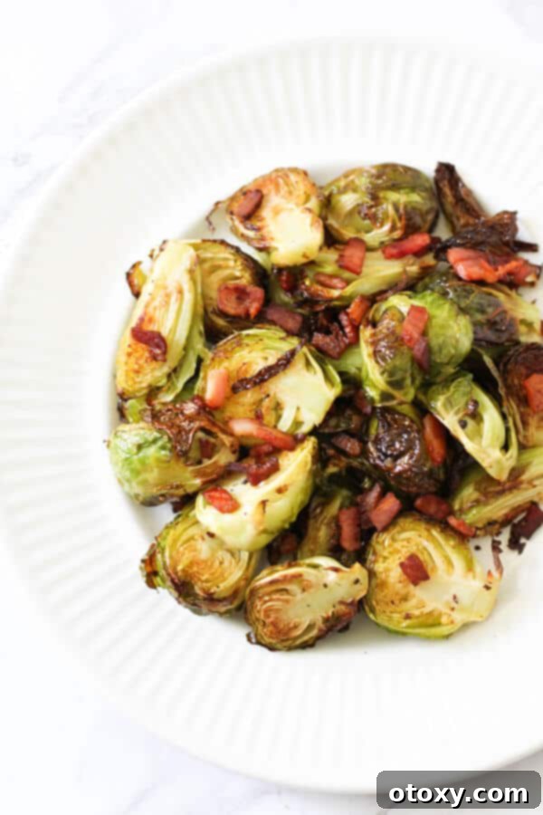 roasted brussels sprouts with bacon on a white plate