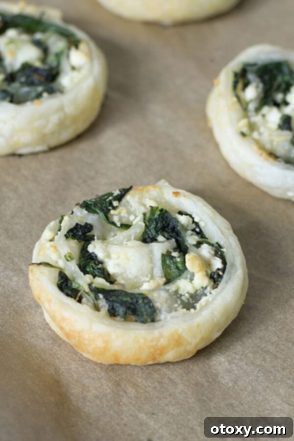 Spinach Feta Pinwheels Ready for Oven or Air Fryer 7 close up on a spinach & feta pinwheel