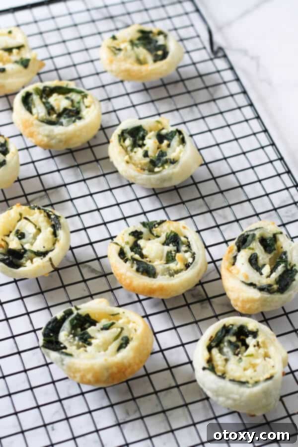 Spinach Feta Pinwheels Ready for Oven or Air Fryer 8 spinach & feta pinwheels on a cooling rack