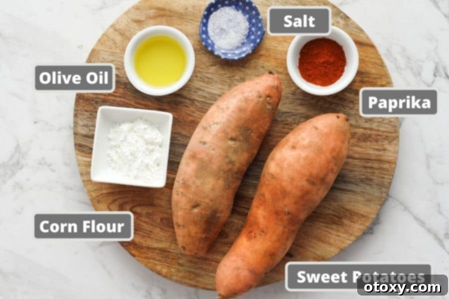 Ingredients for sweet potato wedges laid out on a wooden board: sweet potatoes, olive oil, cornstarch, and paprika.