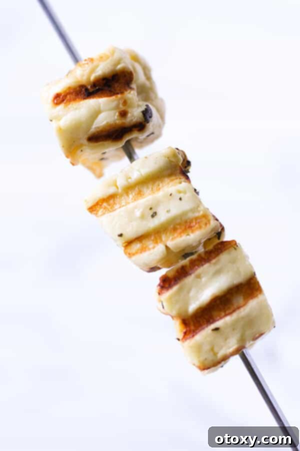 grilled halloumi cubes on a skewer.