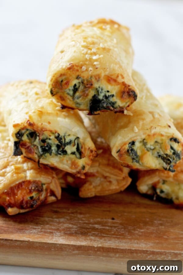 Spinach Ricotta Rolls Oven or Air Fried 3 Spinach and ricotta rolls stacked in a pyramid shape, ready to be enjoyed as a delightful snack or appetizer.