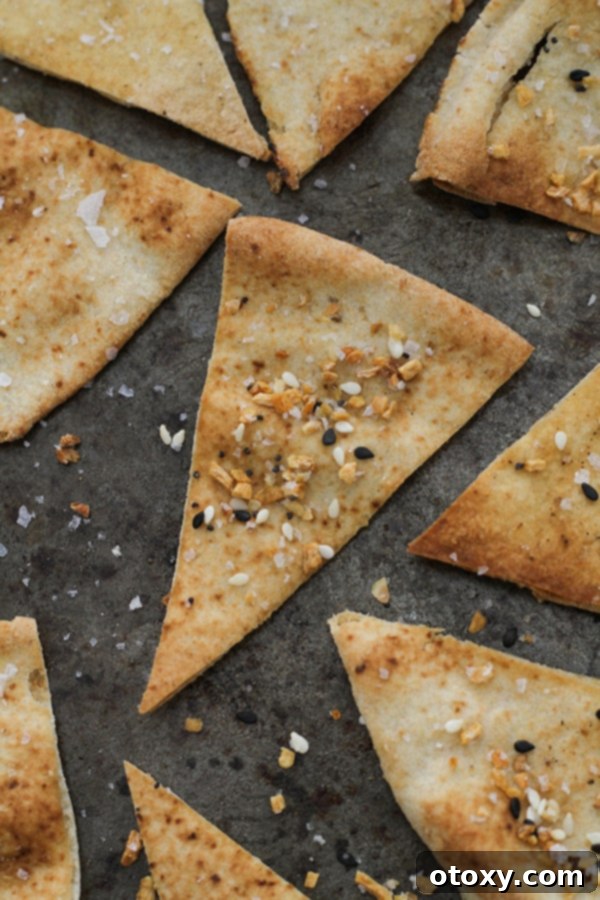 pita chips on a baking tray. A baking sheet is filled with golden-brown pita triangles, neatly arranged in a single layer, just out of the oven.