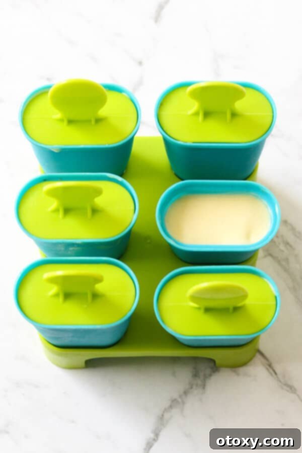 A tray of empty popsicle molds ready to be filled with the delicious mango mixture.