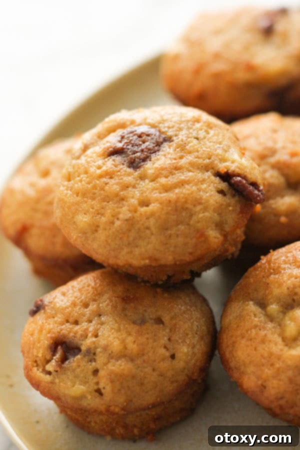 mini banana muffins stacked on a plate.