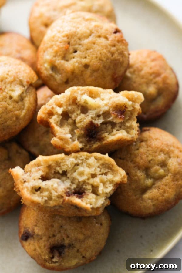 mini banana muffins stacked on a plate.