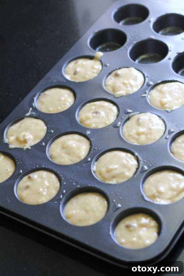 muffin tray filled with mixture.