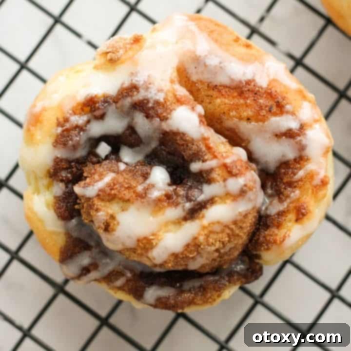 No-yeast cinnamon rolls on a wire rack covered with a sweet glaze.
