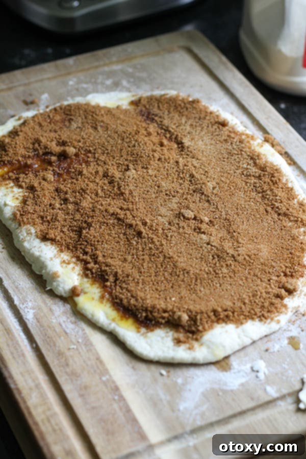 Two-ingredient dough covered in a delicious cinnamon sugar mixture, ready to be rolled.