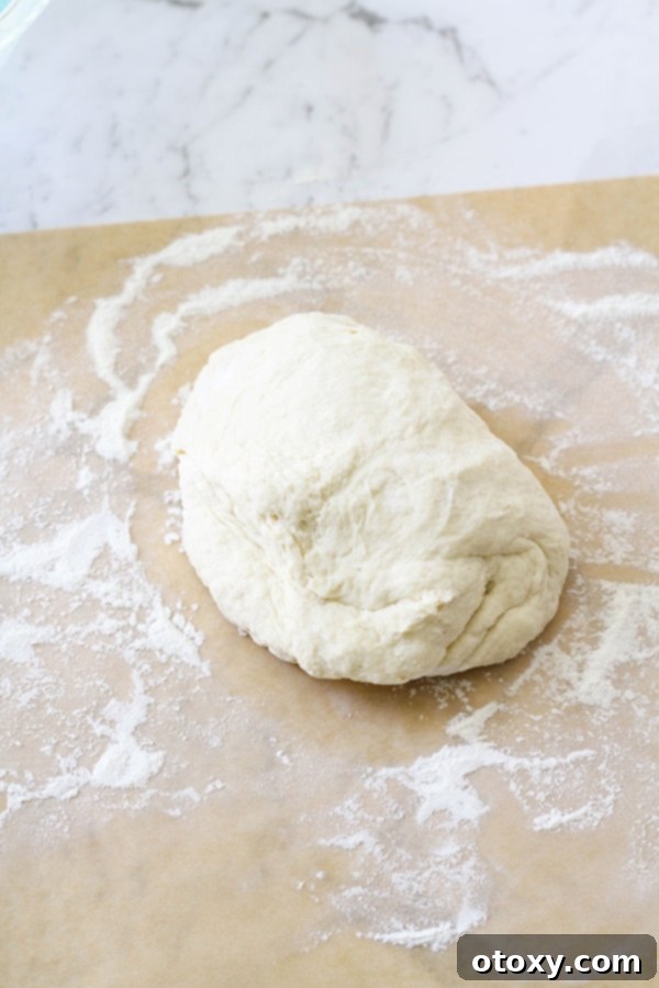 Vegemite Cheese Pinwheels 5 a ball of dough on a piece of parchment paper.