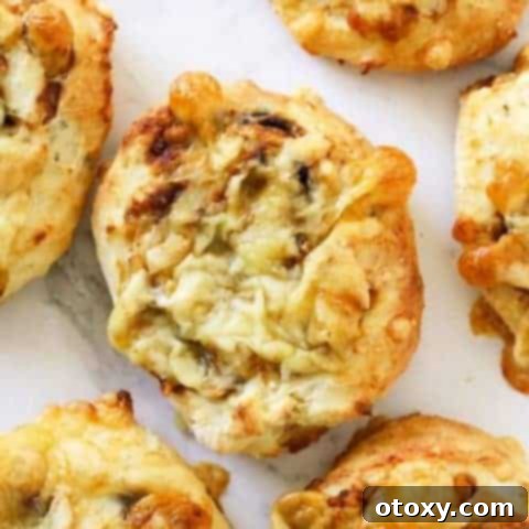 Vegemite Cheese Pinwheels 10 cheese and vegemite scrolls lying on a marble board.