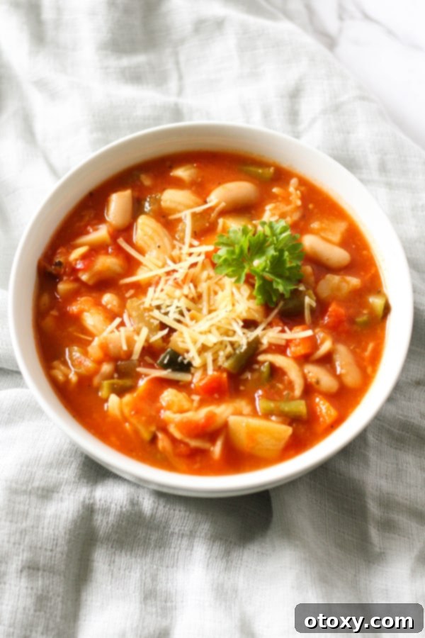 A close-up shot of a bowl of Italian Minestrone Soup, showcasing its rich texture, vibrant colors, and chunky vegetables, inviting a taste.