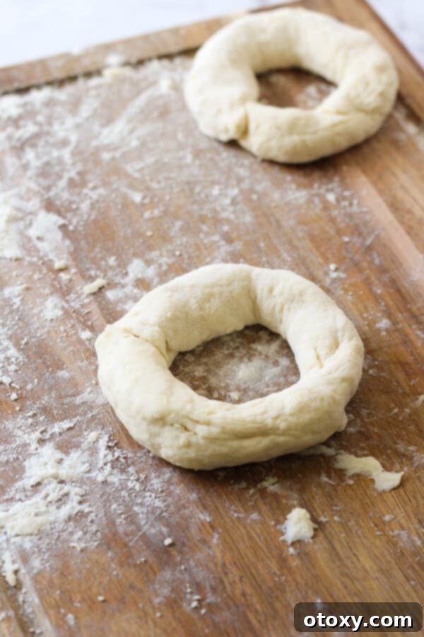 Speedy Yeast Free Bagels 7 Hands demonstrating how to pinch the ends of a dough rope together to form a bagel shape.