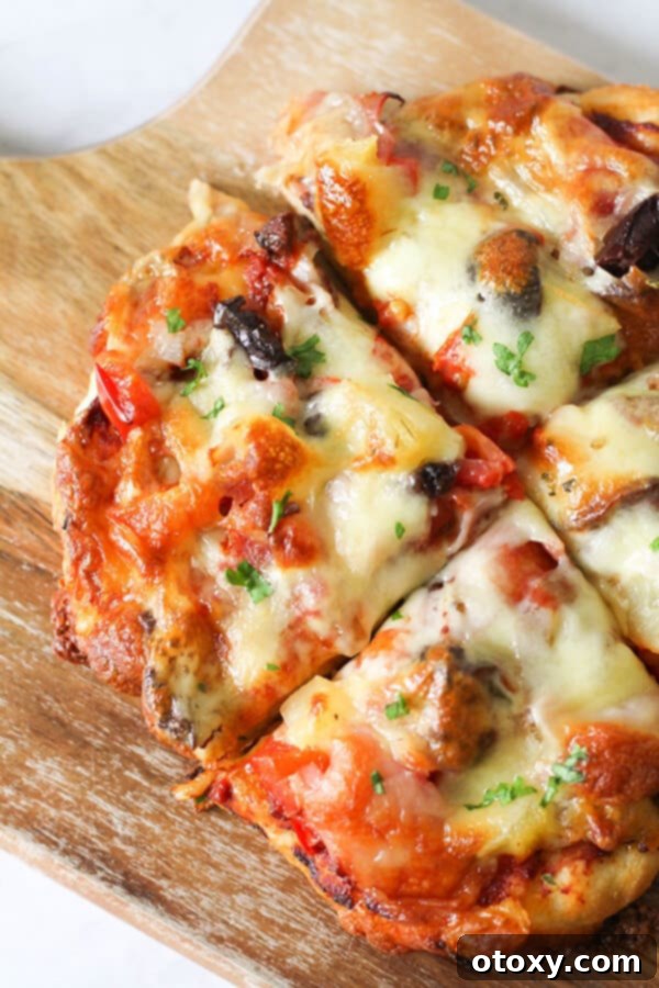 Another view of a freshly baked supreme pizza, showing crispy crust and golden cheese.