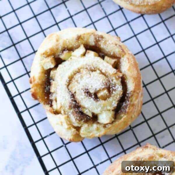 Soft and fluffy apple cinnamon rolls, filled with spiced apples and cinnamon, perfect for a cozy breakfast or treat.
