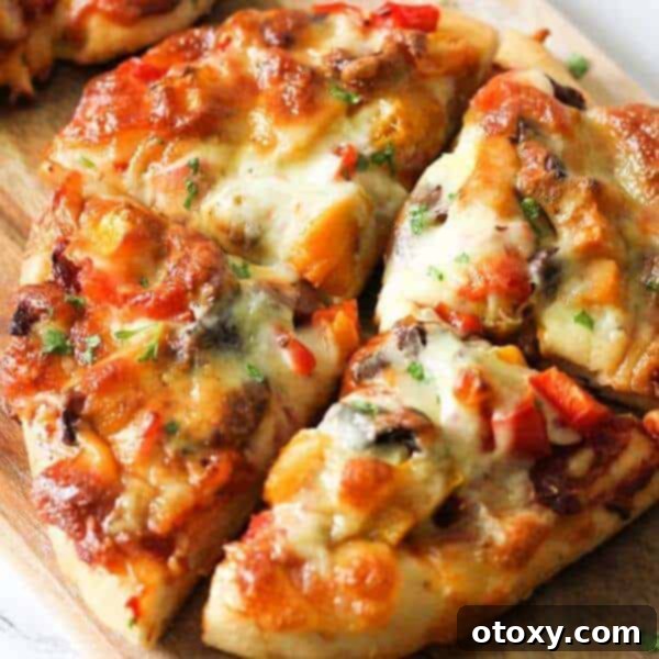 Gourmet roast pumpkin pizza, topped with roasted butternut squash, feta, bell peppers, olives, and mozzarella, on a homemade dough base.