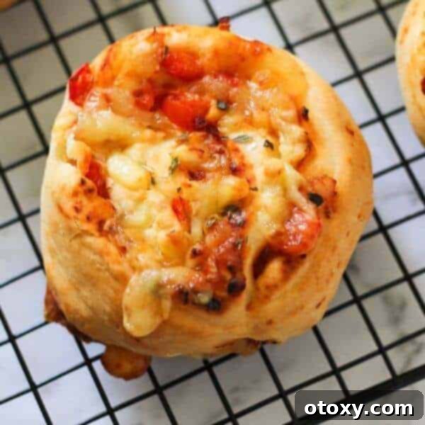 Irresistible pizza scrolls, generously filled with melted cheese and crispy bacon, ideal for lunchboxes or appetizers.