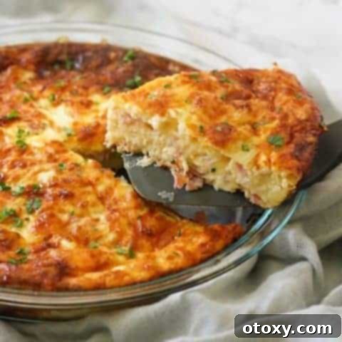 Crustless Ham and Cheese Impossible Quiche in a glass pie dish, presented with a rustic charm and ready to be served.