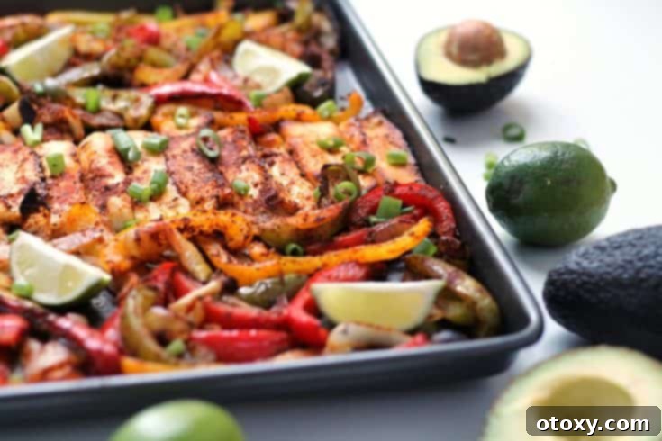 Roasted Halloumi Fajitas with colorful peppers and onions on a sheet pan.