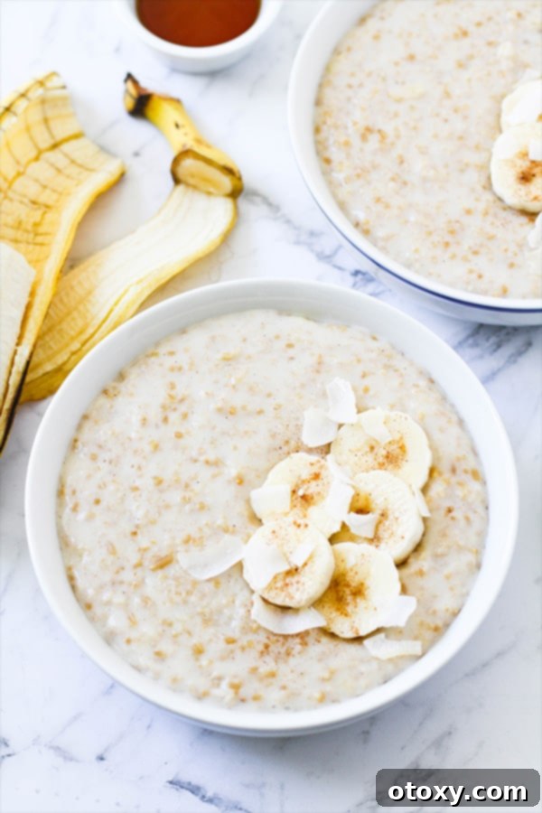 two bowls of banana maple steel cut oats topped with banana slices