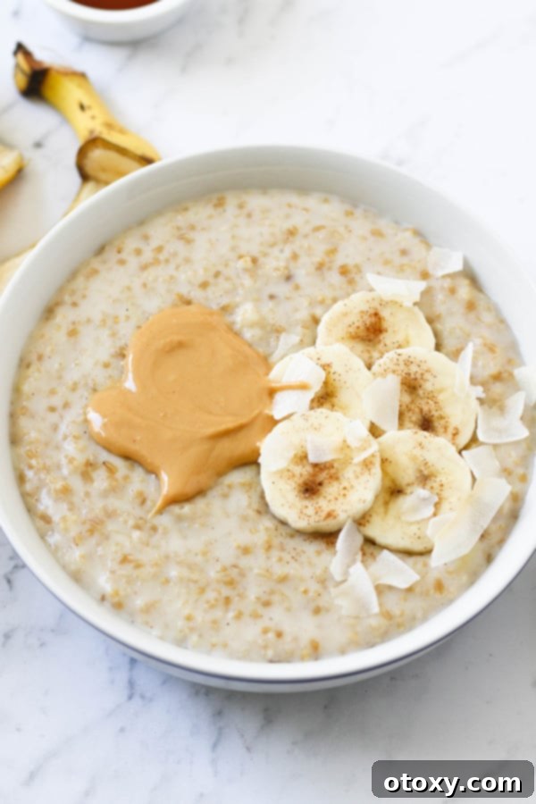 a bowl of banana maple steel cut oats topped with peanut butter and banana slices