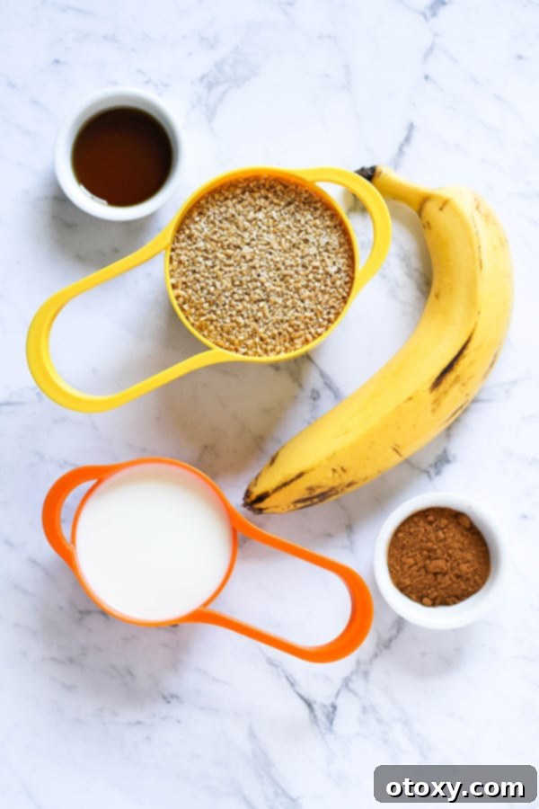ingredients to make banana maple steel cut oats on a white marble background