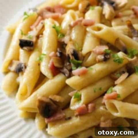 Creamy Carbonara on a white plate.
