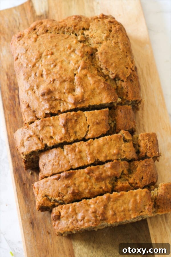 Velvety Buttermilk Banana Bread 10 Buttermilk Banana Bread, beautifully sliced and arranged on a rustic wooden board, ready for serving.