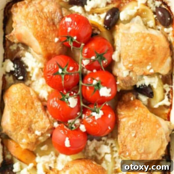 A rustic one-pan Greek Chicken and Potatoes bake, featuring golden chicken thighs, roasted lemon potatoes, olives, and blistered cherry tomatoes, ready to serve.