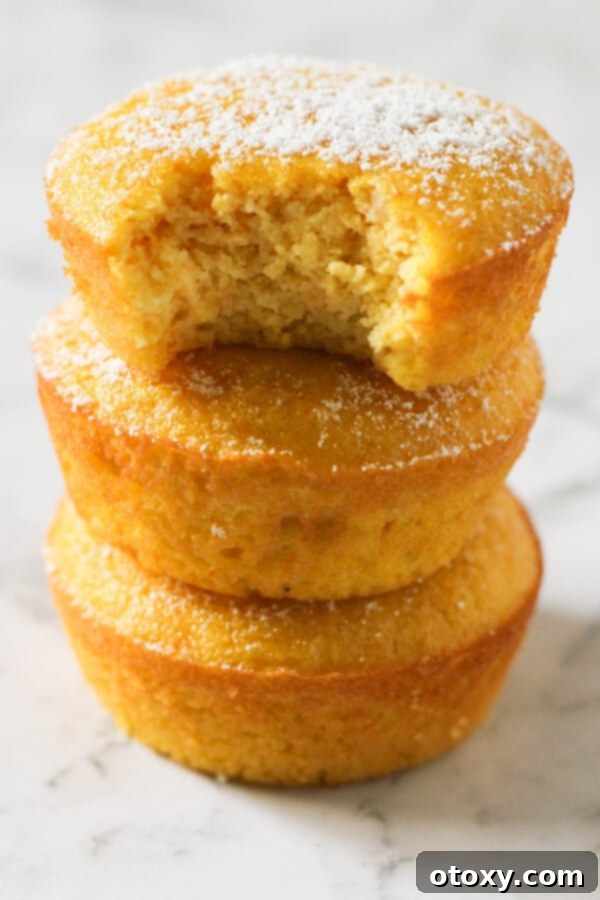 Zesty Orange Almond Tea Cakes 2 Orange and almond cakes stacked on top of each other on a marble board, ready to be served.