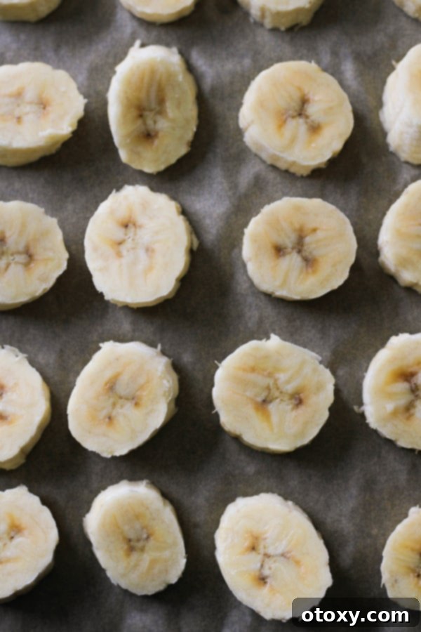 A close-up view of perfectly frozen banana slices, free from frost and ready to be used, displayed in a transparent freezer bag.