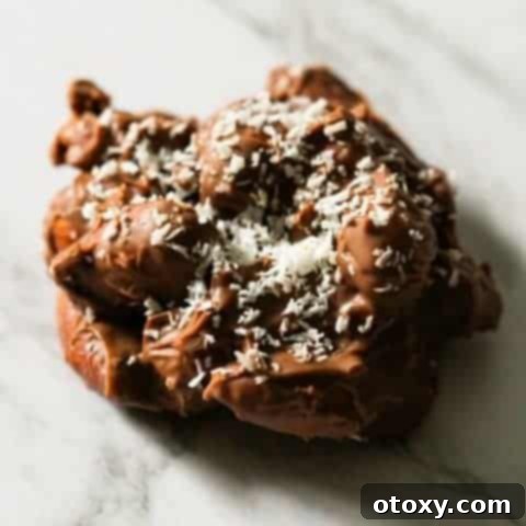 a chocolate covered almond cluster on a marble background
