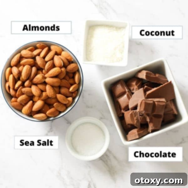 ingredients for chocolate covered almonds on a marble background.
