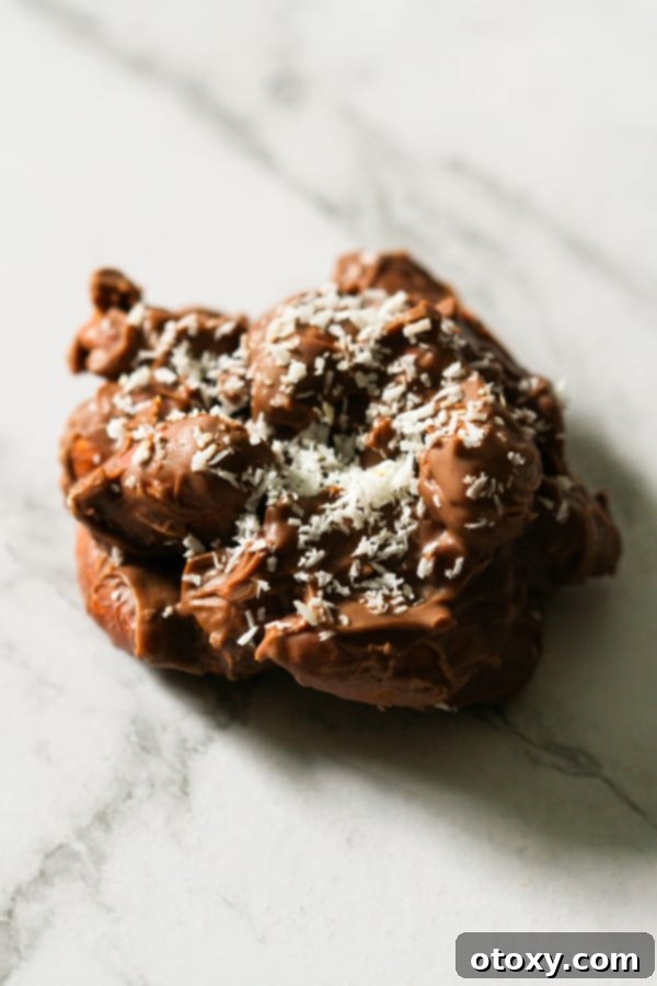 a chocolate covered almond cluster on a marble background