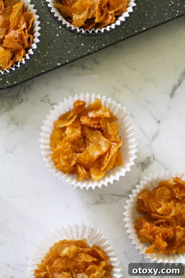 Honey joys in white paper liners on a marble background.