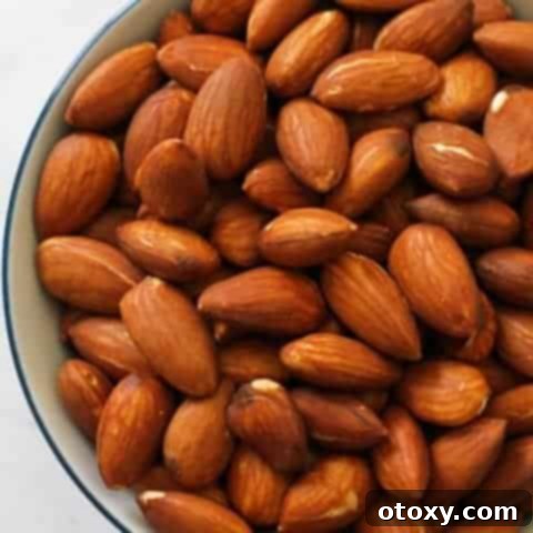 Perfectly dry roasted almonds presented in a small, inviting bowl, ready to be enjoyed as a snack or incorporated into a meal.